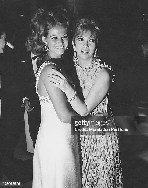Italian actress Claudia Cardinale and Italian actress Gina Lollobrigida , wearing Bulgari jewels, attending a party held by the Counts Cicogna for...