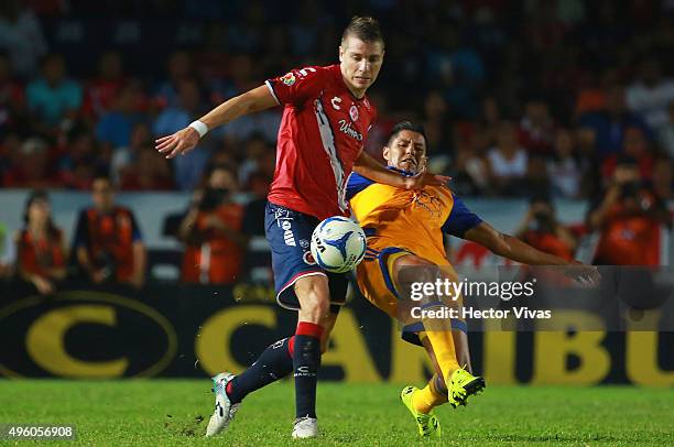 Hugo Ayala of Tigres struggles for the ball with Julio Cesar Furch of Veracruz during the 16th round match between Veracruz and Tigres UANL as part...