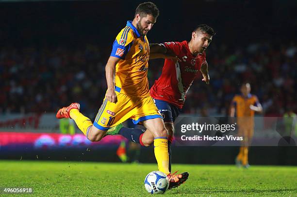 Andre Pierre Gignac of Tigres struggles for the ball with Edgar Andrade of Veracruz during the 16th round match between Veracruz and Tigres UANL as...