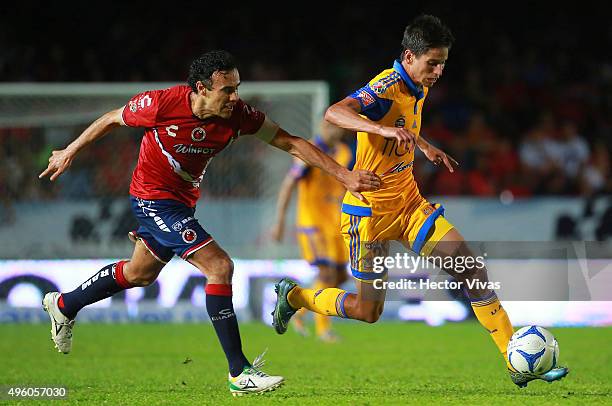 Jurgen Damm of Tigres drives the ball as Leobardo Lopez of Veracruz holds him during the 16th round match between Veracruz and Tigres UANL as part of...