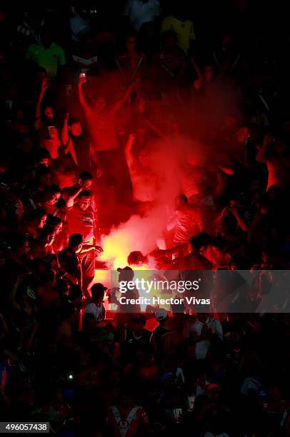 Fans of Veracruz light a fire on the stands during the 16th round match between Veracruz and Tigres UANL as part of the Apertura 2015 Liga MX at Luis...