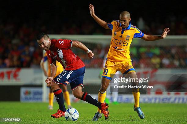Guido Pizarro of Tigres struggles for the ball with Fernando Meneses of Veracruz during the 16th round match between Veracruz and Tigres UANL as part...
