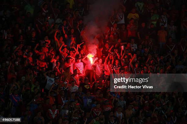 Fans of Veracruz light a flare during the 16th round match between Veracruz and Tigres UANL as part of the Apertura 2015 Liga MX at Luis Pirata de la...