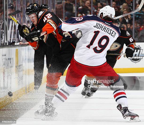 Josh Manson of the Anaheim Ducks gets hit by Ryan Johansen of the Columbus Blue Jackets on November 6, 2015 at Honda Center in Anaheim, California.