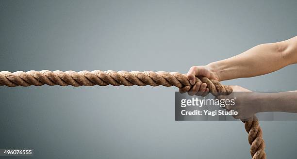 the hands of man pulling the rope - pull foto e immagini stock