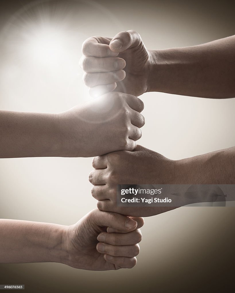 Hands of two stacking