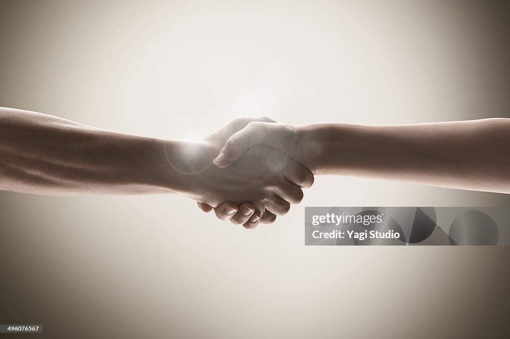 The hands of men and women holding hands