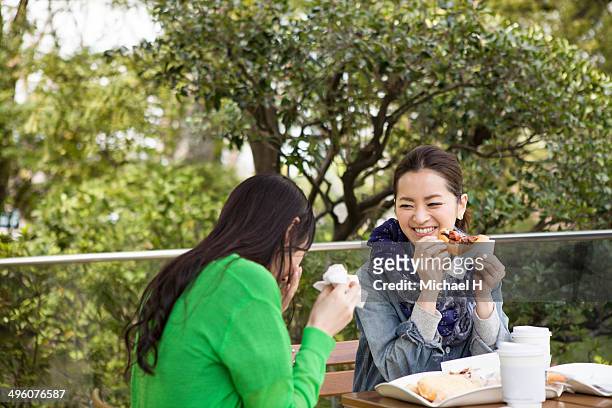 fenmale friends having lunch in the cafe. - mid adult women stock pictures, royalty-free photos & images