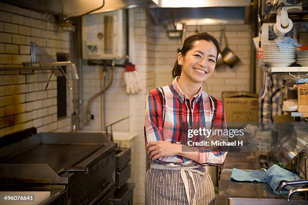 chef smiling in restaurant kitchen - 女性　日本人　笑顔　30代 ストックフォトと画像
