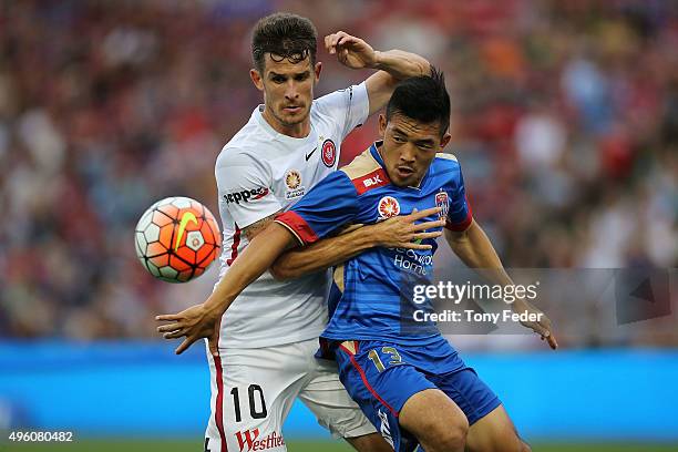 Kjie Lee of the Jets contests the ball with Dario Vidosic of the Wanderers during the round five A-League match between the Newcastle Jets and the...