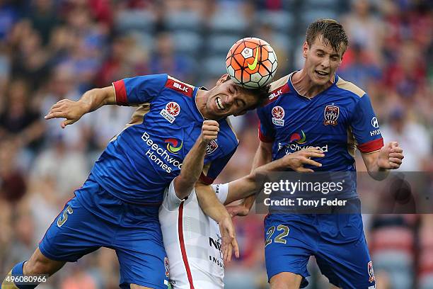 Benjamin Kantarovski and Lachlan Jackson of the Jets contest a header with Mitch Nichols of the Wanderers during the round five A-League match...