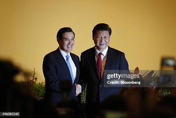 Ma Ying-jeou, Taiwan's president, left, and Xi Jinping, China's president, shake hands during a photo session ahead of their meeting in Singapore, on...