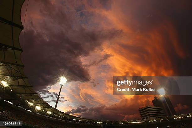 Storm clouds are seen as the sun sets after play on day three of the First Test match between Australia and New Zealand at The Gabba on November 7,...