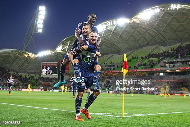 Besart Berisha of the Victory celebrates with Kosta Barbarouses and Jason Geria after scoring their second goal during the FFA Cup Final match...