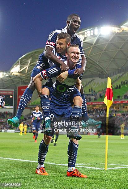 Besart Berisha of the Victory celebrates with Kosta Barbarouses and Jason Geria after scoring their second goal during the FFA Cup Final match...
