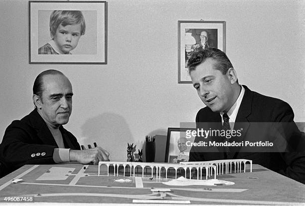 Brazilian architect Oscar Niemeyer and another man analysing the Palazzo Mondadori scale model. The Italian publisher Giorgio Mondadori has recently...