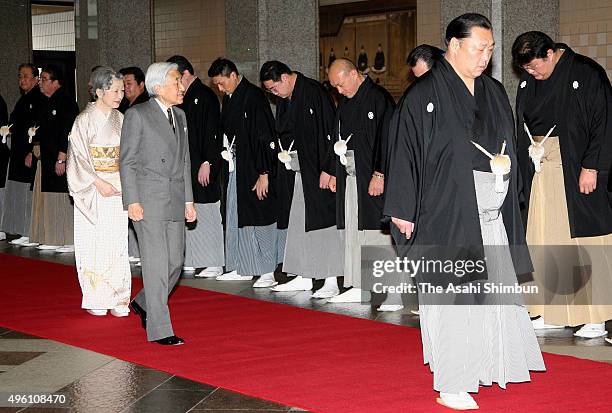 Emperor Akihito and Empress Michiko are escorted by Japan Sumo Association President Kitanoumi during the Grand Sumo New Year Tournament at Ryogoku...