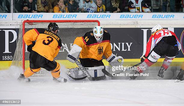 Stephan Daschner, Dennis Endras of Team Germany and Gregory Hofmann of Team Swiss during the game between Germany and the Swiss on November 6, 2015...