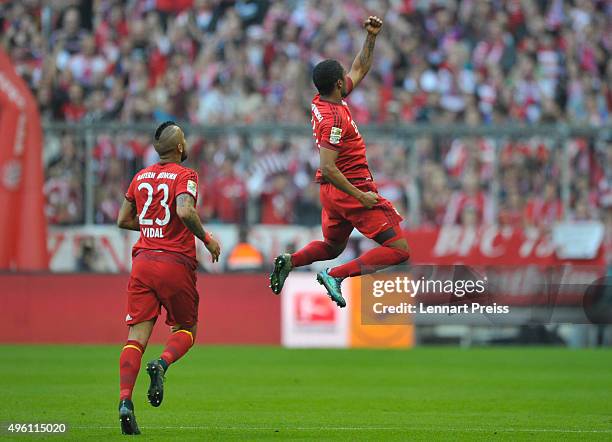 Douglas Costa and Arturo Vidal of Bayern Muenchen celebrate their side's second goal during the Bundesliga match between FC Bayern Muenchen and VfB...