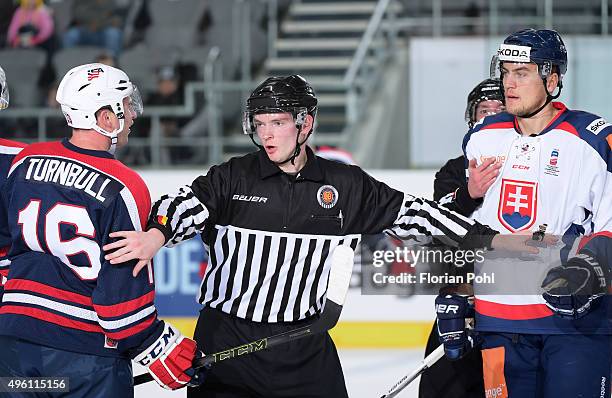 Travis Turnbull of Team USA, linesman Jonas Merten and Andrej Stastny of Team Slovakia during the game between USA and the Slovakia on November 6,...