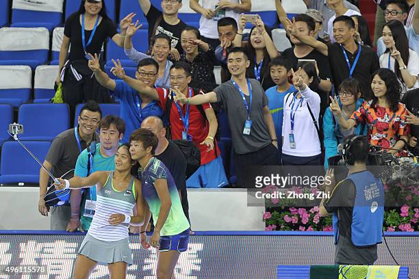 Chen Liang of China and Yafan Wang of China take selfie with fans after the doubles match against Klaudia Jans-Ignacik of Poland and Andreja Klepac...