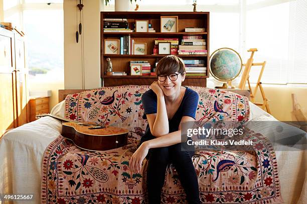 Portrait of young painter sitting in couch at home