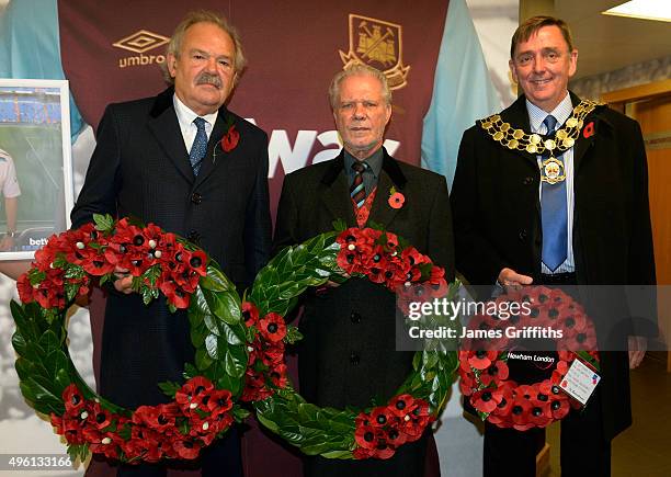 Wreath bearers John Woods of Everton, David Gold of West Ham United and Sir Robin Wales, the Mayor of Newham pose prior to the Barclays Premier...