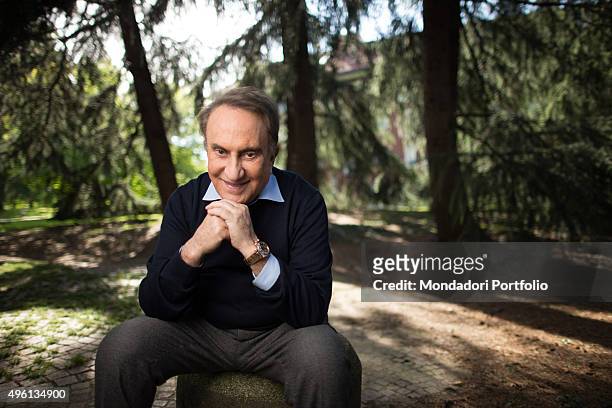 The journalist Emilio Fede posing smiling in a park of Milano 2. Segrate, Italy. 9th May 2014