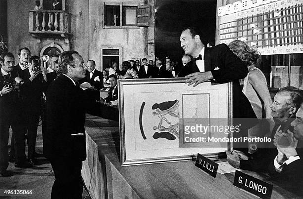 Italian writer Giorgio Bassani winning the Campiello Prize with the novel The heron. Bassani receives from the lawyer Mario Valeri Manera a picture...
