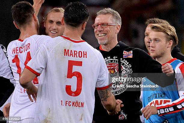 Dominik Maroh of Koeln is hugged by head coach Peter Stoeger after the Bundesliga match between Bayer Leverkusen and 1. FC Koeln at BayArena on...