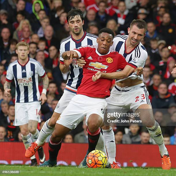 Anthony Martial of Manchester United in action with Claudio Yacob and Gareth McAuley of West Bromwich Albion during the Barclays Premier League match...