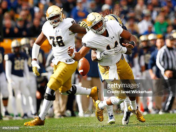 DeShone Kizer of the Notre Dame Fighting Irish fumbles the ball after being hit by KeiVarae Russell of the Pittsburgh Panthers in the first quarter...