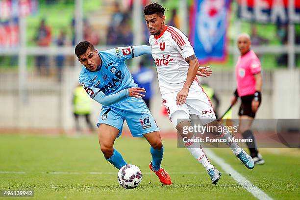 Paulo Magalhaes of U de Chile fights for the ball with Cesar Pinares of Deportes Iquique during a match between Deportes Iquique and U de Chile as...