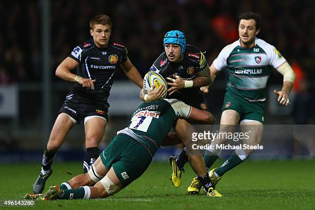 Jack Nowell of Exeter Chiefs looks for support as Lachlan McCaffreey of Leicester Tigers holds on in the tackle during the Aviva Premiership match...