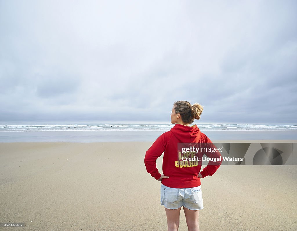 Female life guard looking out to sea.