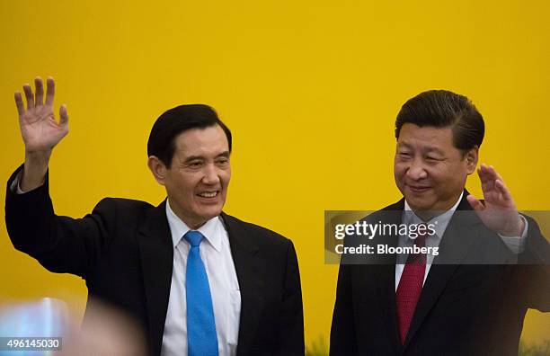 Ma Ying-jeou, Taiwan's president, left, and Xi Jinping, China's president, wave during a photo session ahead of their meeting in Singapore, on...