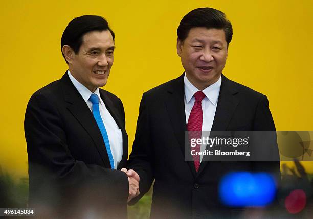 Ma Ying-jeou, Taiwan's president, left, and Xi Jinping, China's president, shake hands during a photo session ahead of their meeting in Singapore, on...