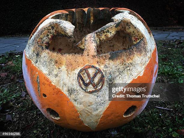 Image was created with a smartphone.) Berlin, Germany A pumpkin in the form of a Volkswagen Bully Bus with engraved VW signs standing on a meadow on...