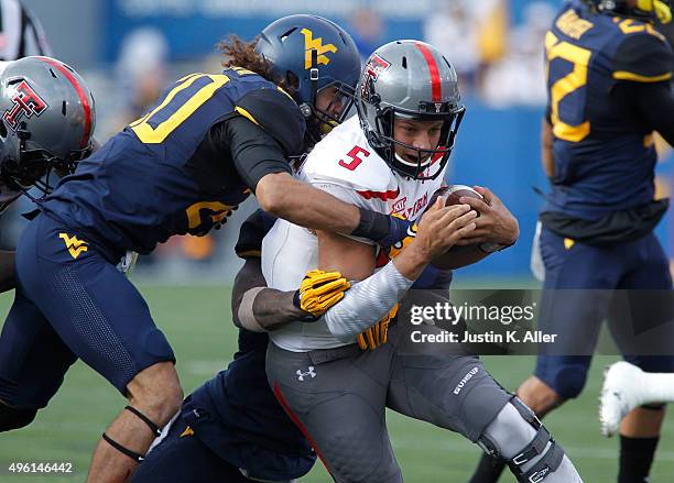 Patrick Mahomes of the Texas Tech Red Raiders is tackled by Edward Muldrow of the West Virginia Mountaineers during the game on November 7, 2015 at...