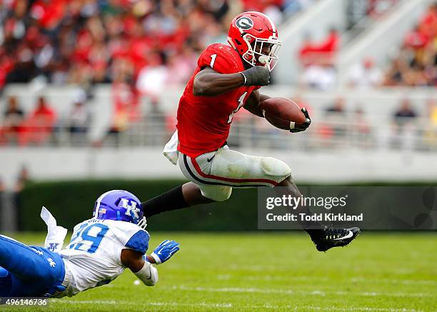 Sony Michel of the Georgia Bulldogs leaps over Derrick Baity of the Kentucky Wildcats in the fourth quarter of the game on November 7, 2015 at...