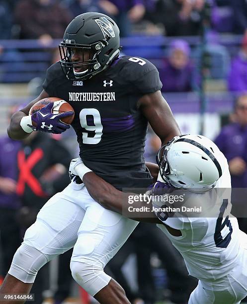 Garrett Dickerson of the Northwestern Wildcats is tackled by Malik Golden of the Penn State Nittany Lions at Ryan Field on November 7, 2015 in...