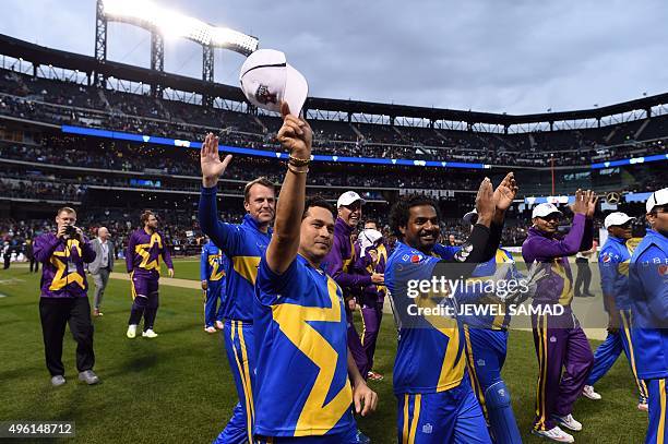Sachin's Blasters captain Sachin Tendulkar other players wave at fans at end of the first of a three-match T20 series against Warne's Warrors at the...