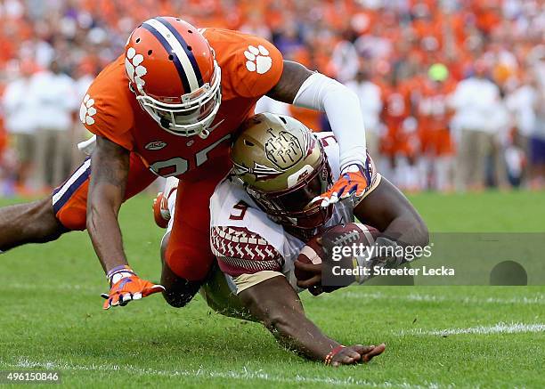 Cordrea Tankersley of the Clemson Tigers tackles Jacques Patrick of the Florida State Seminoles during their game at Memorial Stadium on November 7,...