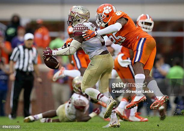 Cordrea Tankersley of the Clemson Tigers knocks the ball away from Jesus Wilson of the Florida State Seminoles during their game at Memorial Stadium...
