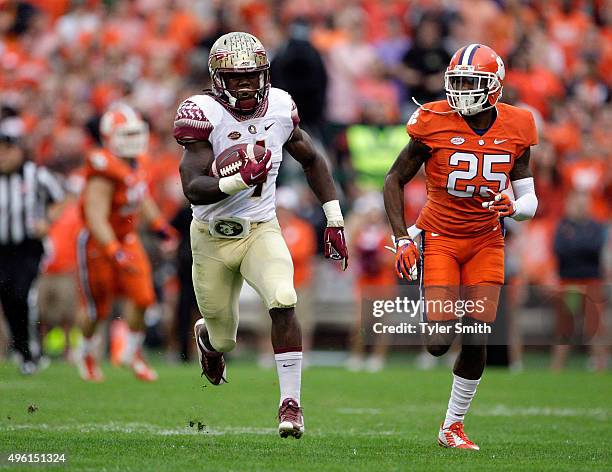 Dalvin Cook of the Florida State Seminoles rushes for a first down past Cordrea Tankersley of the Clemson Tigers during a game at Memorial Stadium on...