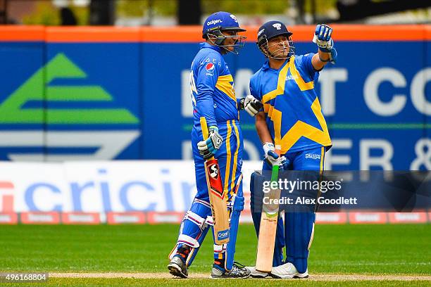 Sachin's Blasters player Sachin Tendulkar speaks to teammate Virender Sehwag during a match in the Cricket All-Stars Series at Citi Field on November...