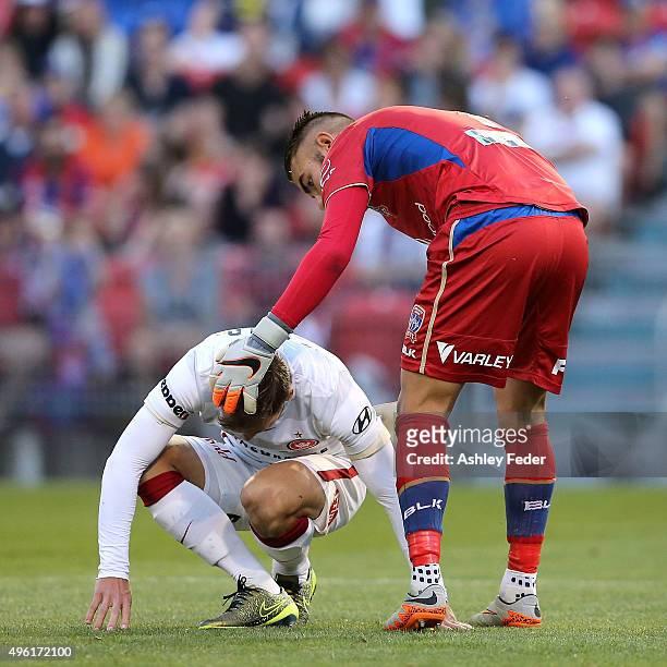 Mark Birighitti of the Jets consoles a Wanderers player after missing at goal during the round five A-League match between the Newcastle Jets and the...