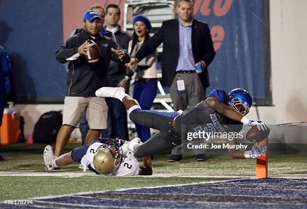 Anthony Miller of the Memphis Tigers dives into the end zone for a touchdown against Lorentez Barbour of the Navy Midshipmenon November 7, 2015 at...