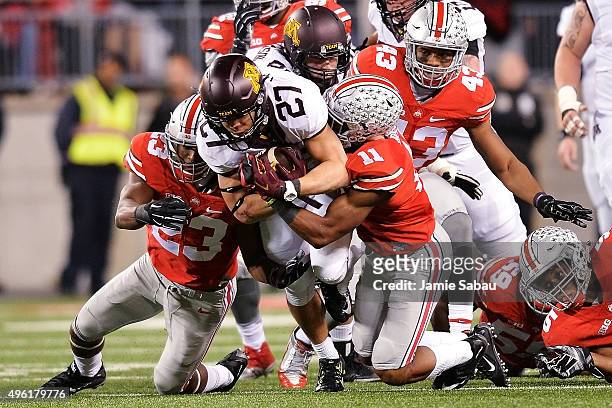 Shannon Brooks of the Minnesota Golden Gophers is brought down by Tyvis Powell of the Ohio State Buckeyes and Vonn Bell of the Ohio State Buckeyes in...