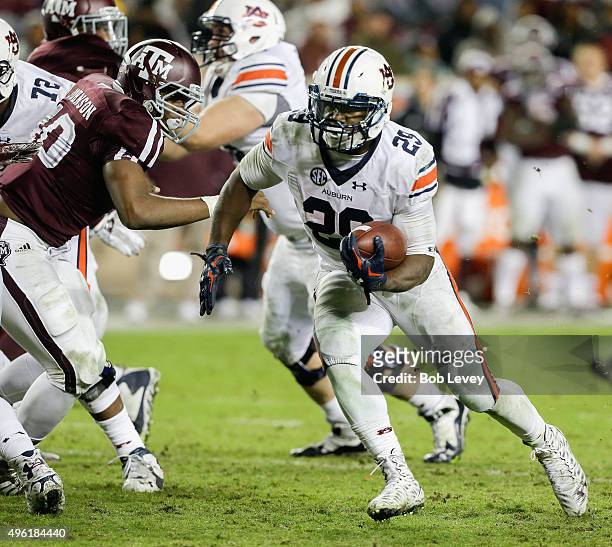 Jovon Robinson of the Auburn Tigers rushes past Jarrett Johnson of the Texas A&M Aggies in the fourth quarter at Kyle Field on November 7, 2015 in...